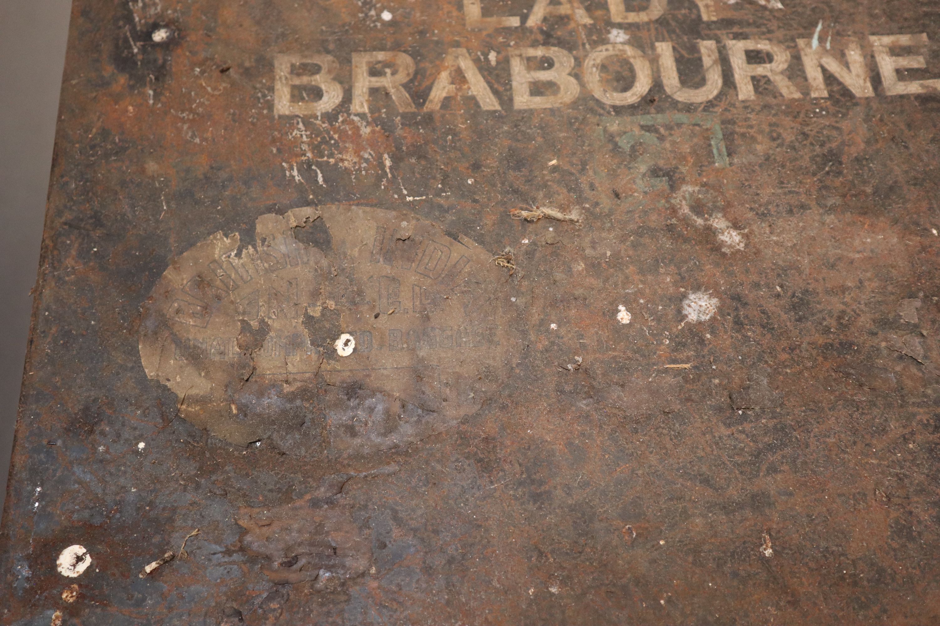 An early 20th century black painted tin travelling trunk, inscribed Lady Brabourne with old British India and Cooks Travel labels, wi
